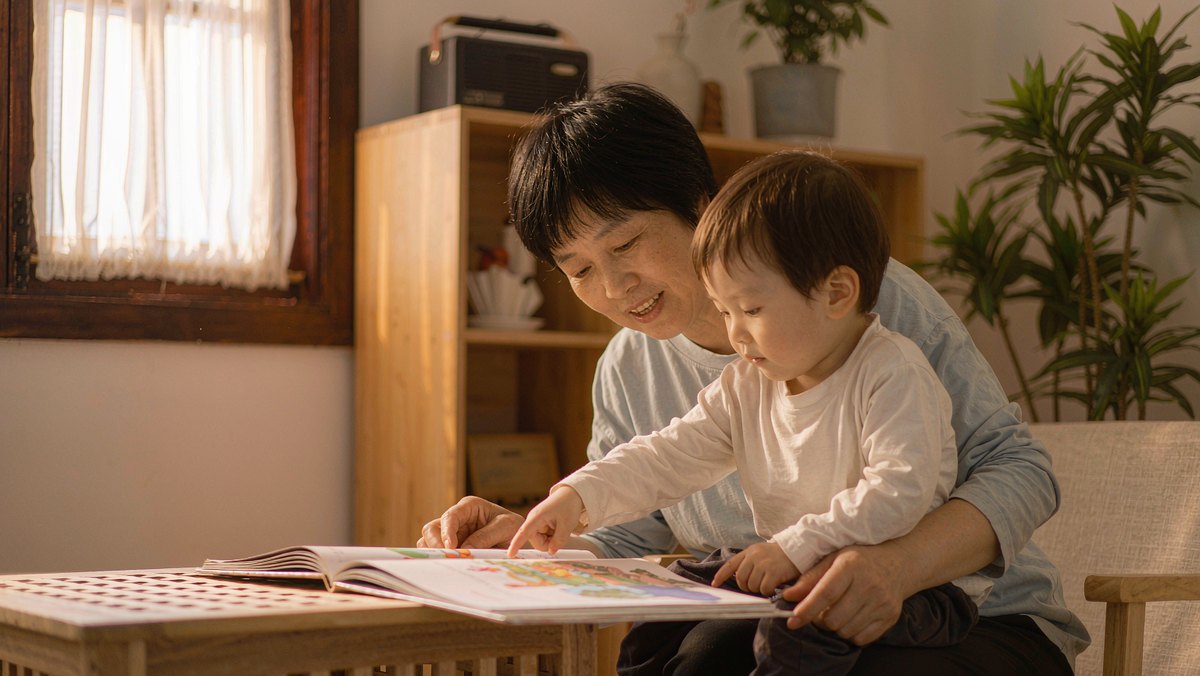 妈妈和孩子一起看绘本,孩子用手指着页面